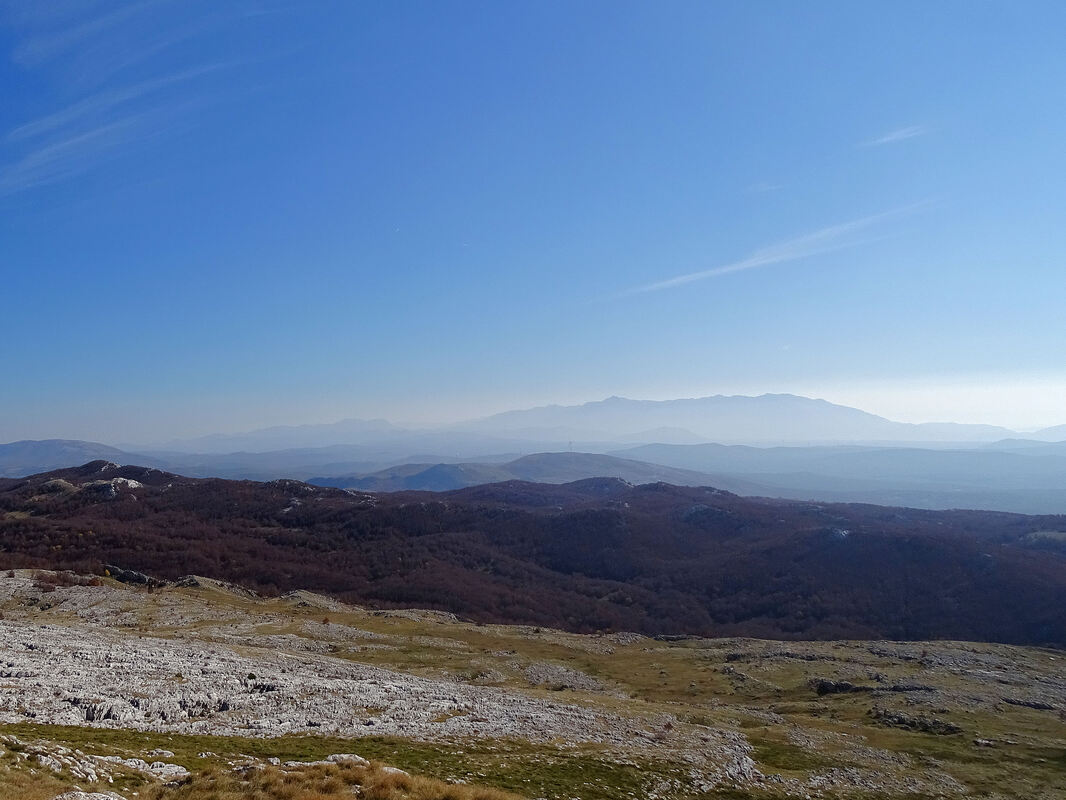 Pogled s kamešničkog vrha Konj u smjeru Biokova (vršni dio, desno) i Rilića (lijevo), vidljivih na horizontu kao dvije planinske mase.