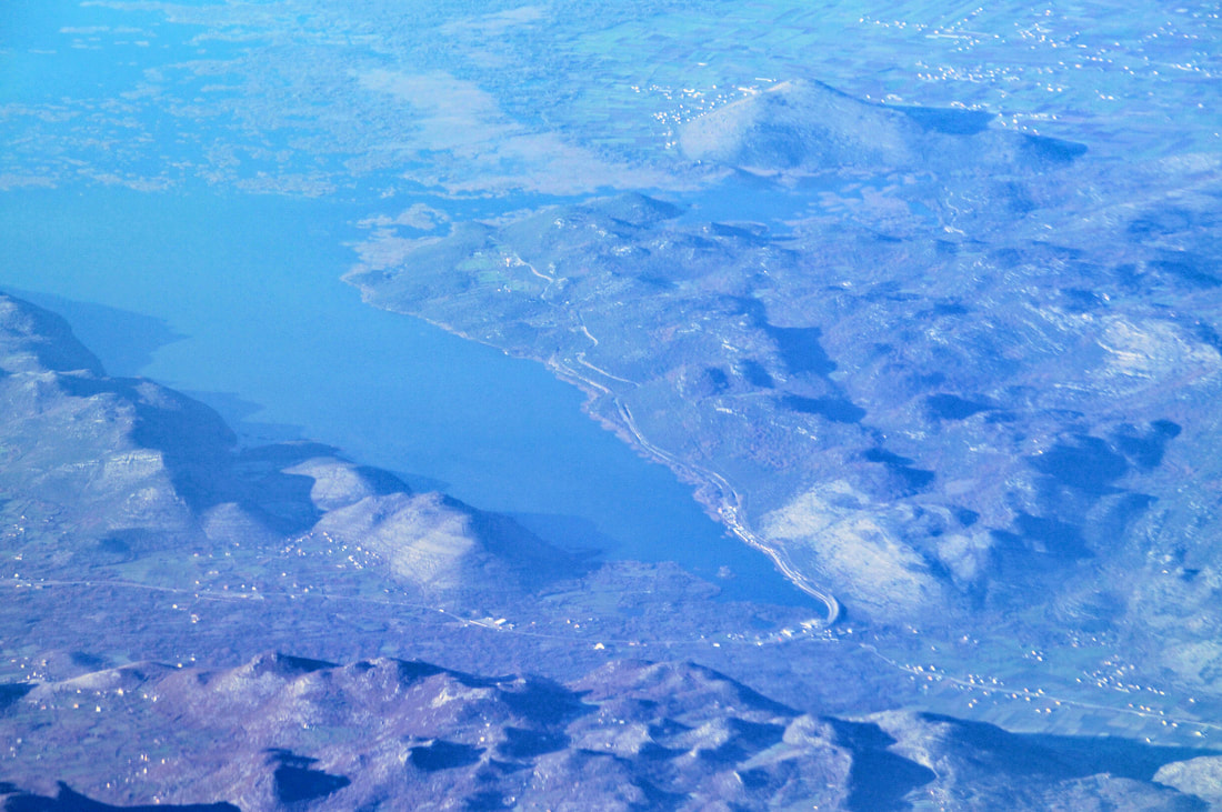 Zračni snimak Hotskog zaljeva, desno od kojega se vidi dio Hotskih brda - najviše od njih, koje se može vidjeti na fotografiji (u pozadini, desno) je brdo Dečić.